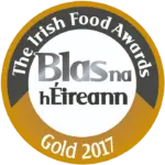 A circular gold and white badge reads "The Irish Food Awards" around the top edge, "Blas na hÉireann" in the center, and "Gold 2017" at the bottom.