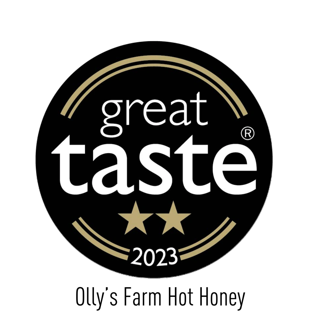 A circular black badge with gold accents reads “great taste” in bold white letters, features two gold stars below the word “taste,” and “2023” written underneath.