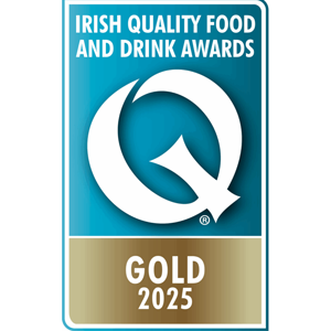 A blue and gold badge displaying a large white "Q" with the text "Irish Quality Food and Drink Awards" above and "Gold 2025" below.