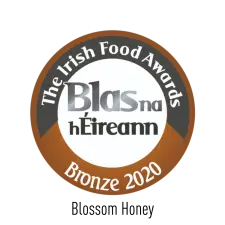A circular badge with "The Irish Food Awards" at the top, "Blas na hÉireann" in the center, and "Bronze 2020" at the bottom, featuring brown, white, and black colors.